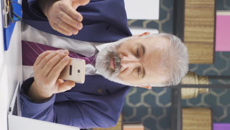 Vertical-video-of-Old-businessman-liking-mobile-application-from-phone.